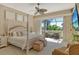 Bright bedroom boasts a four-poster bed and large sliding doors that lead to a private balcony at 1007 3Rd E St, Palmetto, FL 34221