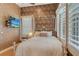 Charming bedroom featuring a queen bed, plantation shutters, and natural lighting at 1007 3Rd E St, Palmetto, FL 34221