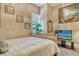 Cozy bedroom with a queen bed, hardwood floors, neutral walls, and natural light at 1007 3Rd E St, Palmetto, FL 34221