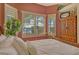 Bedroom with neutral walls, shuttered windows with water views, and wood floors at 1007 3Rd E St, Palmetto, FL 34221