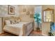 Bright bedroom with a queen bed, neutral walls, carpet flooring, and natural light at 1007 3Rd E St, Palmetto, FL 34221