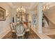 Elegant dining room features a grand chandelier, a large table, and easy access to adjacent living spaces at 1007 3Rd E St, Palmetto, FL 34221