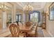Formal dining room features a large table, elegant chandelier, and abundant natural light from the windows at 1007 3Rd E St, Palmetto, FL 34221