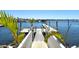 Picturesque dock with clear water and boats in a community with palm trees in the background at 1007 3Rd E St, Palmetto, FL 34221
