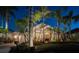 Charming home exterior at night, with lush tropical landscaping and inviting lighting at 1007 3Rd E St, Palmetto, FL 34221