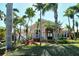 Charming single-story home boasts lush landscaping and swaying palms, creating a tranquil tropical oasis at 1007 3Rd E St, Palmetto, FL 34221