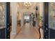 Spacious foyer features tile flooring, a grand chandelier, and views to the staircase and living area at 1007 3Rd E St, Palmetto, FL 34221
