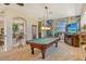 Expansive game room features a pool table, a TV, and a tropical-themed mural on the wall at 1007 3Rd E St, Palmetto, FL 34221