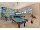Spacious game room features a pool table, a TV, and a mural depicting a tropical paradise at 1007 3Rd E St, Palmetto, FL 34221