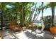 Screened lanai with wicker furniture, stone floor, and lush tropical foliage overlooking the water at 1007 3Rd E St, Palmetto, FL 34221