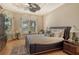 Well-lit bedroom featuring wood floors, plantation shutters, and comfortable decor at 1007 3Rd E St, Palmetto, FL 34221