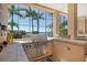 Outdoor kitchen with stainless steel grill with waterfront views, perfect for enjoying the outdoors at 1007 3Rd E St, Palmetto, FL 34221