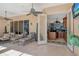 A covered patio with lounge chairs offers an entrance into the home with a wet bar at 1007 3Rd E St, Palmetto, FL 34221