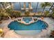 Breathtaking aerial view of the sparkling pool and spa, nestled by the waterfront and dock at 1007 3Rd E St, Palmetto, FL 34221