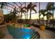 Screened-in pool area with spa and view of waterfront at 1007 3Rd E St, Palmetto, FL 34221