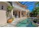 Enclosed pool area with an outdoor seating area, columns, and an upper-level balcony at 1007 3Rd E St, Palmetto, FL 34221