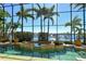 Inviting pool area inside a screened enclosure with views of boats along the intercoastal waterway at 1007 3Rd E St, Palmetto, FL 34221