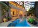 Luxurious covered pool with outdoor seating, balconies and spa at 1007 3Rd E St, Palmetto, FL 34221