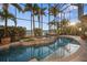 Relax by this gorgeous pool with a built-in spa, lush plants, and waterfront views at 1007 3Rd E St, Palmetto, FL 34221