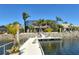 Waterfront home with screened lanai and dock, set against clear blue skies and water at 1007 3Rd E St, Palmetto, FL 34221
