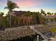 Beautiful waterfront home with private dock and tropical landscaping at sunset at 1007 3Rd E St, Palmetto, FL 34221