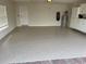 Spacious garage featuring epoxy flooring, built-in cabinets, and ample storage space at 11629 Garessio Ln, Sarasota, FL 34238