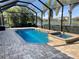 Screened-in pool area with jacuzzi and a view of a pond at 13223 Ramblewood Trl, Lakewood Ranch, FL 34211