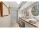 Bathroom featuring double sinks, stylish tile countertops, and modern fixtures at 1612 Pine Harrier Cir, Sarasota, FL 34231