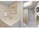 Bathroom with a modern vanity, framed mirror, and a shower-tub combination with neutral shower curtain at 1612 Pine Harrier Cir, Sarasota, FL 34231