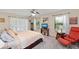 Bedroom with ceiling fan, two windows, and an accent chair at 1612 Pine Harrier Cir, Sarasota, FL 34231