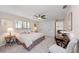 Bedroom with ceiling fan, a side table with lamp, and closet storage at 1612 Pine Harrier Cir, Sarasota, FL 34231