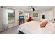Bedroom with ceiling fan, two windows, and an accent chair at 1612 Pine Harrier Cir, Sarasota, FL 34231