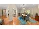 Open dining room with hardwood floors, a modern light fixture, and ample natural light at 1612 Pine Harrier Cir, Sarasota, FL 34231