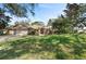 Charming single story home with mature trees and a lush green front lawn at 1612 Pine Harrier Cir, Sarasota, FL 34231