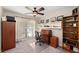 Functional office space with a desk, shelving, comfortable chair, and natural light from the large window at 1612 Pine Harrier Cir, Sarasota, FL 34231