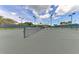 Well-maintained tennis courts featuring new nets and a shaded viewing area on a sunny day at 1612 Pine Harrier Cir, Sarasota, FL 34231