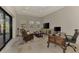 Comfortable living room with a leather chair, a ceiling fan, and sliding glass doors at 16531 Kendleshire Ter, Lakewood Ranch, FL 34202