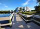 Picturesque water view of the condo complex from a wooden dock surrounded by lush landscaping at 2001 Bal Harbor Blvd # 2301, Punta Gorda, FL 33950