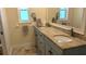 Bright bathroom featuring double sinks, granite countertops, and modern fixtures at 221 Sorrento Dr, Osprey, FL 34229