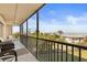 Balcony with seating and views of lush landscaping and a bay in the distance at 25188 Marion Ave # E208, Punta Gorda, FL 33950