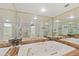 Bathroom featuring a jacuzzi style tub, vanity, mirrors, and plenty of natural light at 25188 Marion Ave # E208, Punta Gorda, FL 33950
