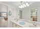 Bright bathroom with a double sink vanity, large mirror, and tile floors at 25188 Marion Ave # E208, Punta Gorda, FL 33950