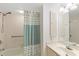 Bathroom featuring shower and tub combination, shower curtain, and sink with storage at 25188 Marion Ave # E208, Punta Gorda, FL 33950