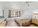 Bedroom with ceiling fan, floral bedding and dresser with mirror at 25188 Marion Ave # E208, Punta Gorda, FL 33950