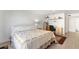 Bedroom with white wood floors, a patterned bedspread, and a built in desk at 25188 Marion Ave # E208, Punta Gorda, FL 33950