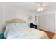 Comfortable bedroom features a ceiling fan, double closet and a bed with patterned bedding at 25188 Marion Ave # E208, Punta Gorda, FL 33950