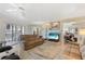 Inviting living room featuring a ceiling fan, fireplace and sliding glass doors to the outdoor balcony at 25188 Marion Ave # E208, Punta Gorda, FL 33950