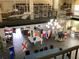 Large community meeting space featuring nautical flags, tables, and multiple ceiling fans at 25188 Marion Ave # E208, Punta Gorda, FL 33950