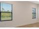 Bedroom features two large windows, neutral paint and tile floors at 309 Potenza Loop, Nokomis, FL 34275