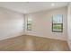 Bedroom with tile floor and two windows with green outdoor views at 309 Potenza Loop, Nokomis, FL 34275